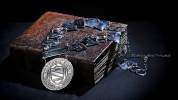 Chancellor's medallion placed over George Durant Bible with brown leather binding.