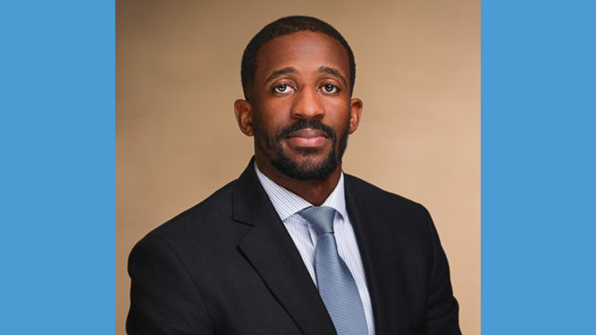 Headshot of Kenny Harris wearing suit.