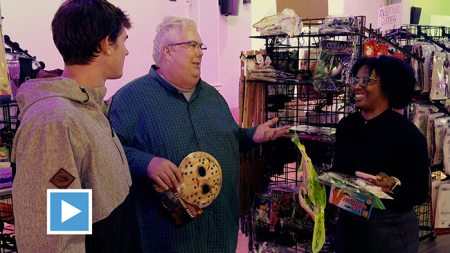 Professor Tim Flood talks with students inside the Heel-O-Ween pop-up store