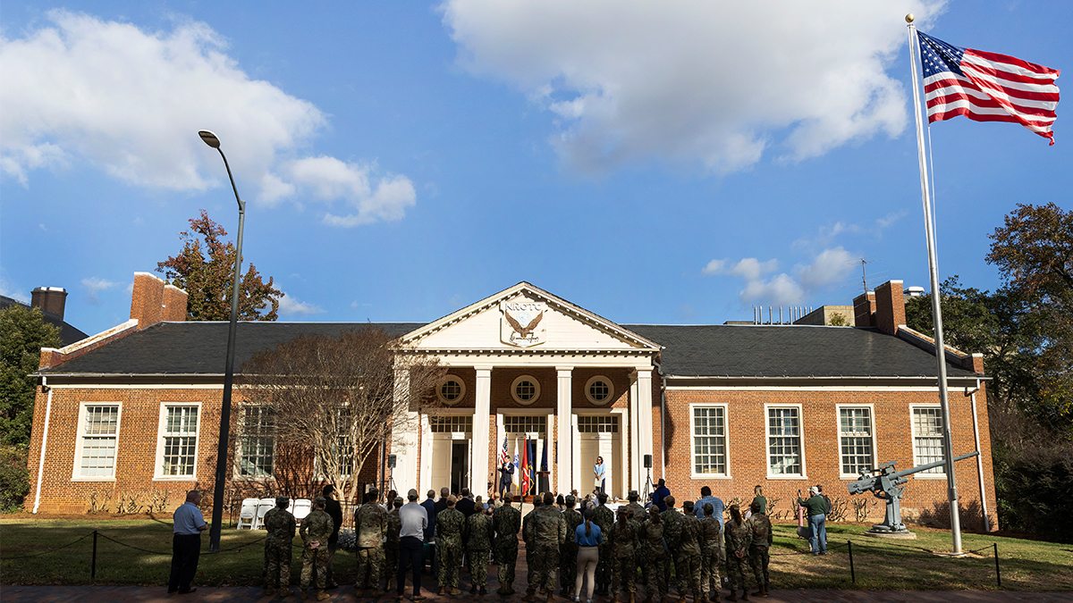 Group of people gathered outside the Naval ROTC Armory on the campus of UNC-Chapel Hill.