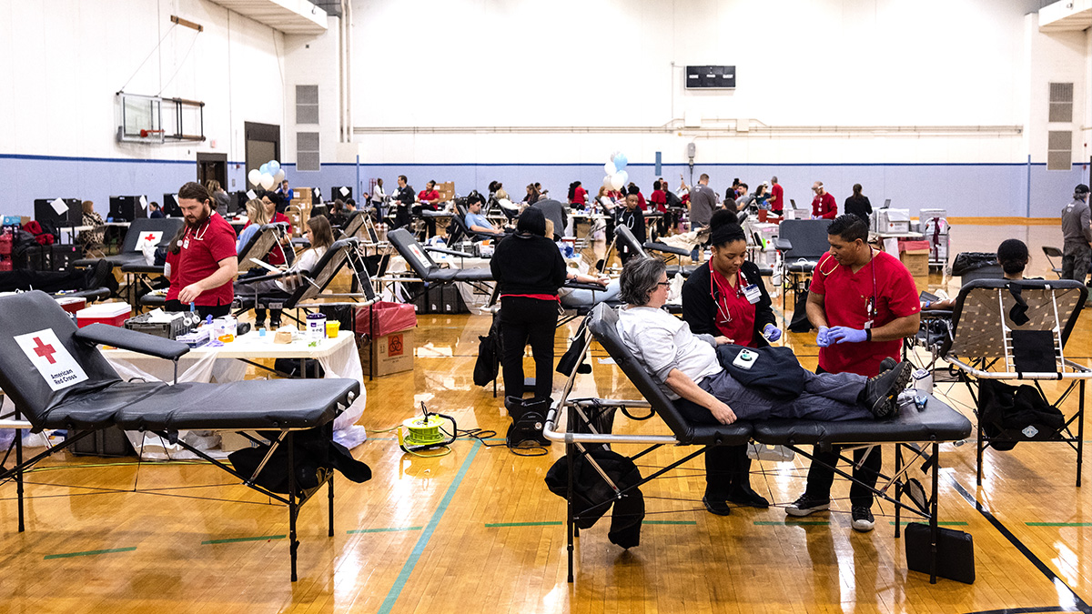 Gymnasium full of people donating blood.