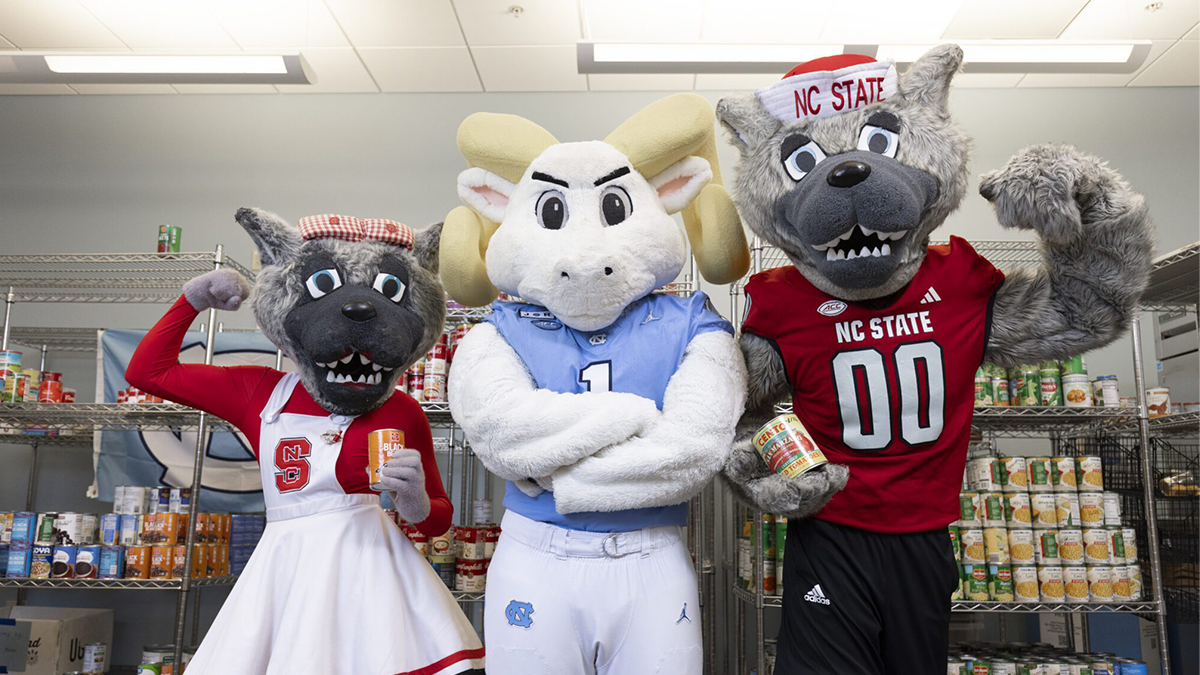 N.C. State mascots Mr. and Mrs. Wulf with U.N.C. mascot Rameses.