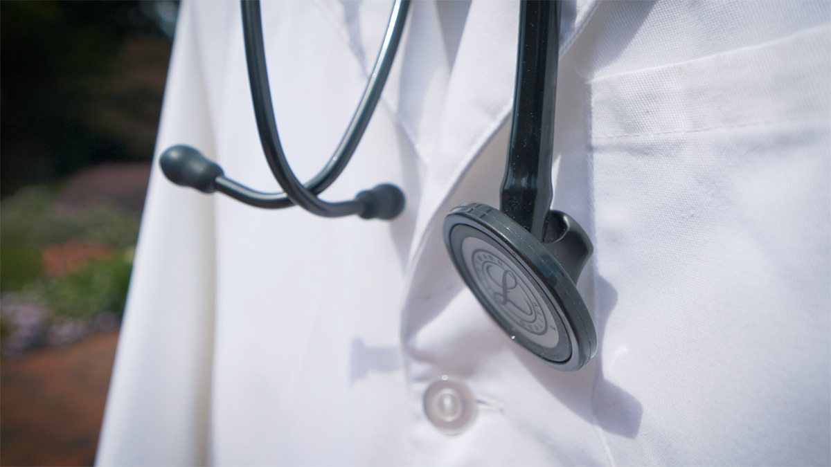 Close up shot of a lab coat and stethoscope.