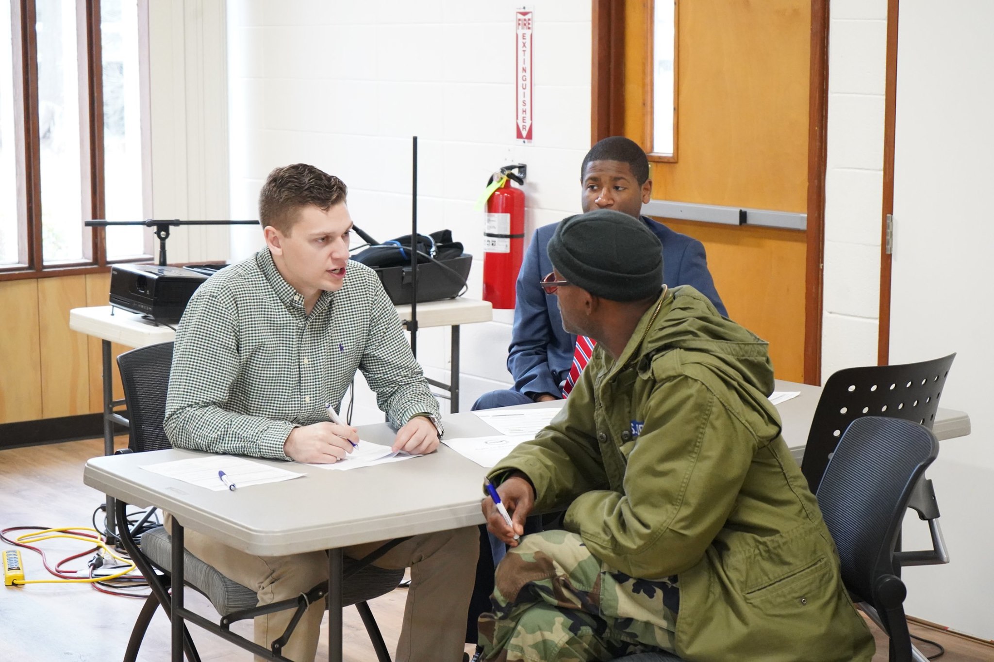 VALOR students meet with veteran at a table